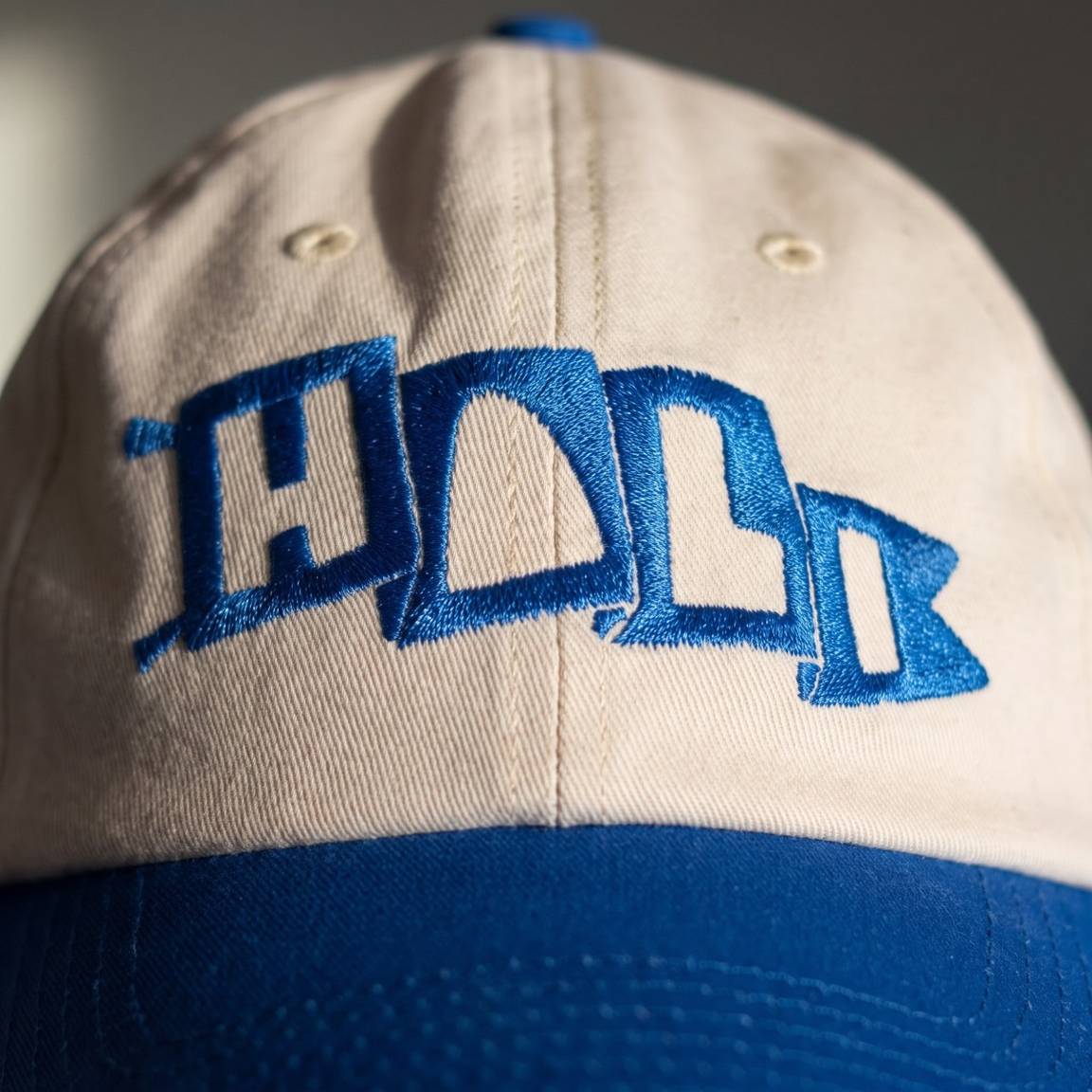 Raking light across the embroidered Hali Flag mark