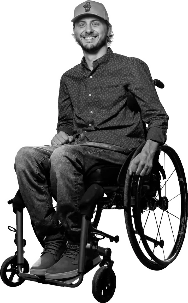 Connor Hirtle smiling while seated in his wheelchair