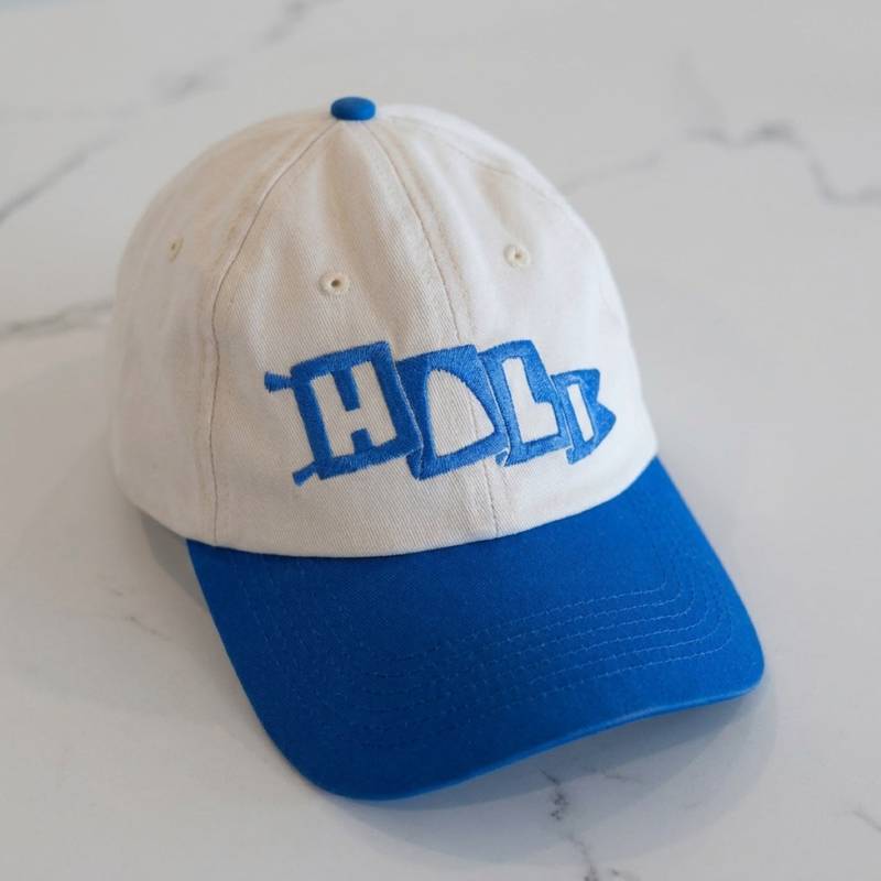 The Hali Hat, a clean flat lay on pale stone